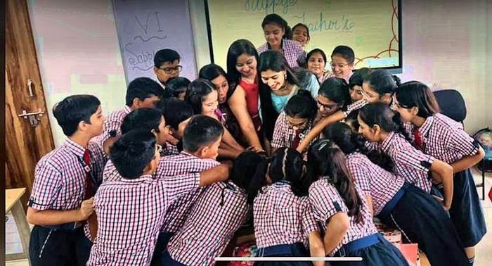 Himanshi Dang surrounded by her students